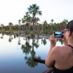 Amanda registrando o pôr do sol na Lagoa das Araras